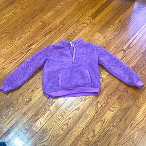 It is a purple puffy sweater